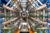 small man dwarfed by CERN ATLAS detector